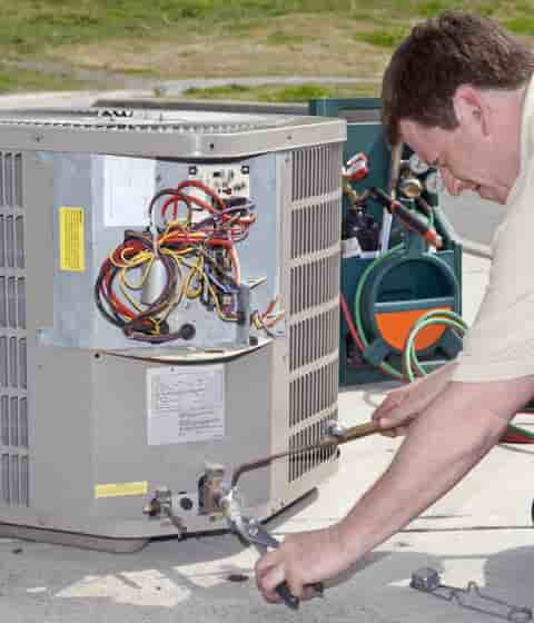 tech working on ac unit